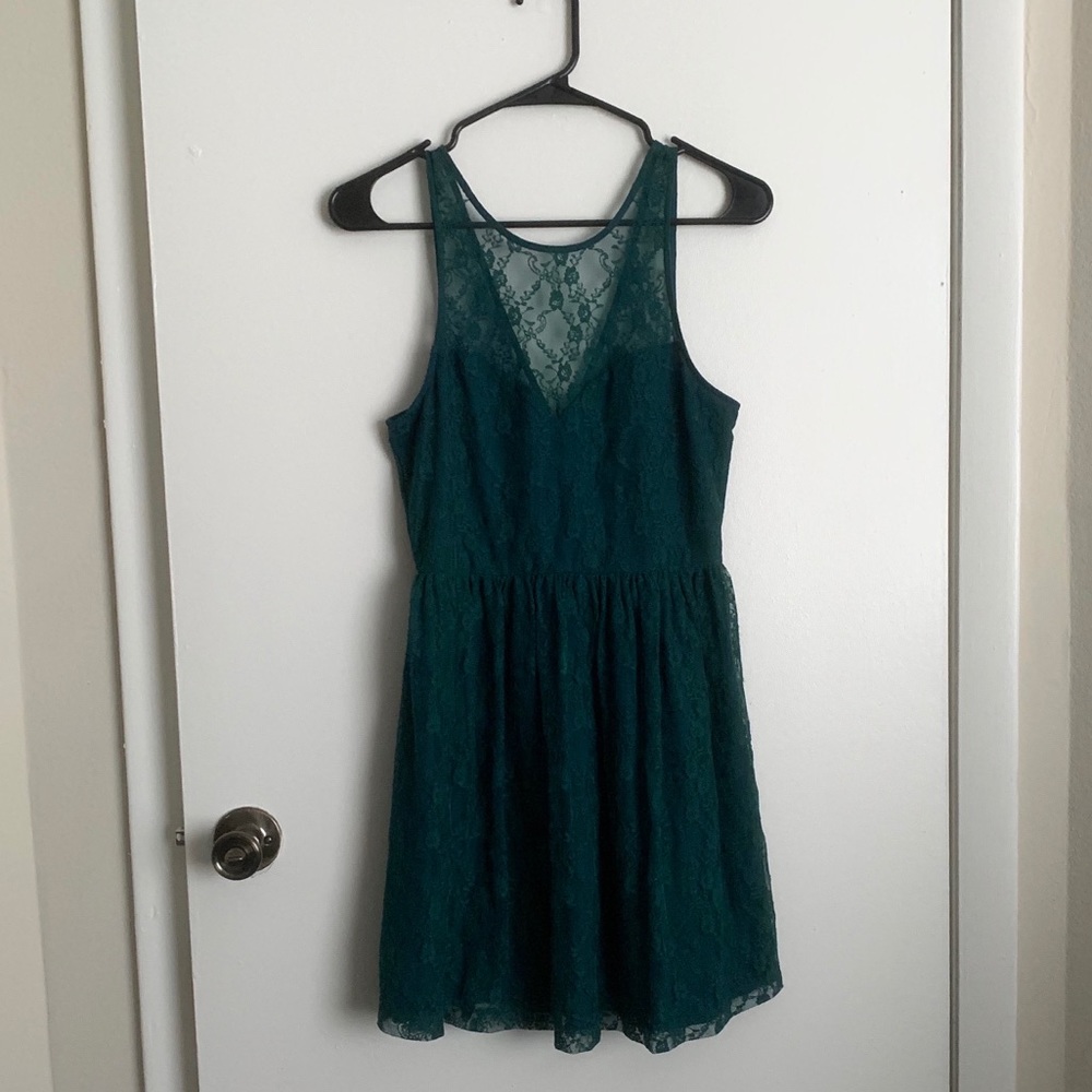 Short green dress with some lace throughout.